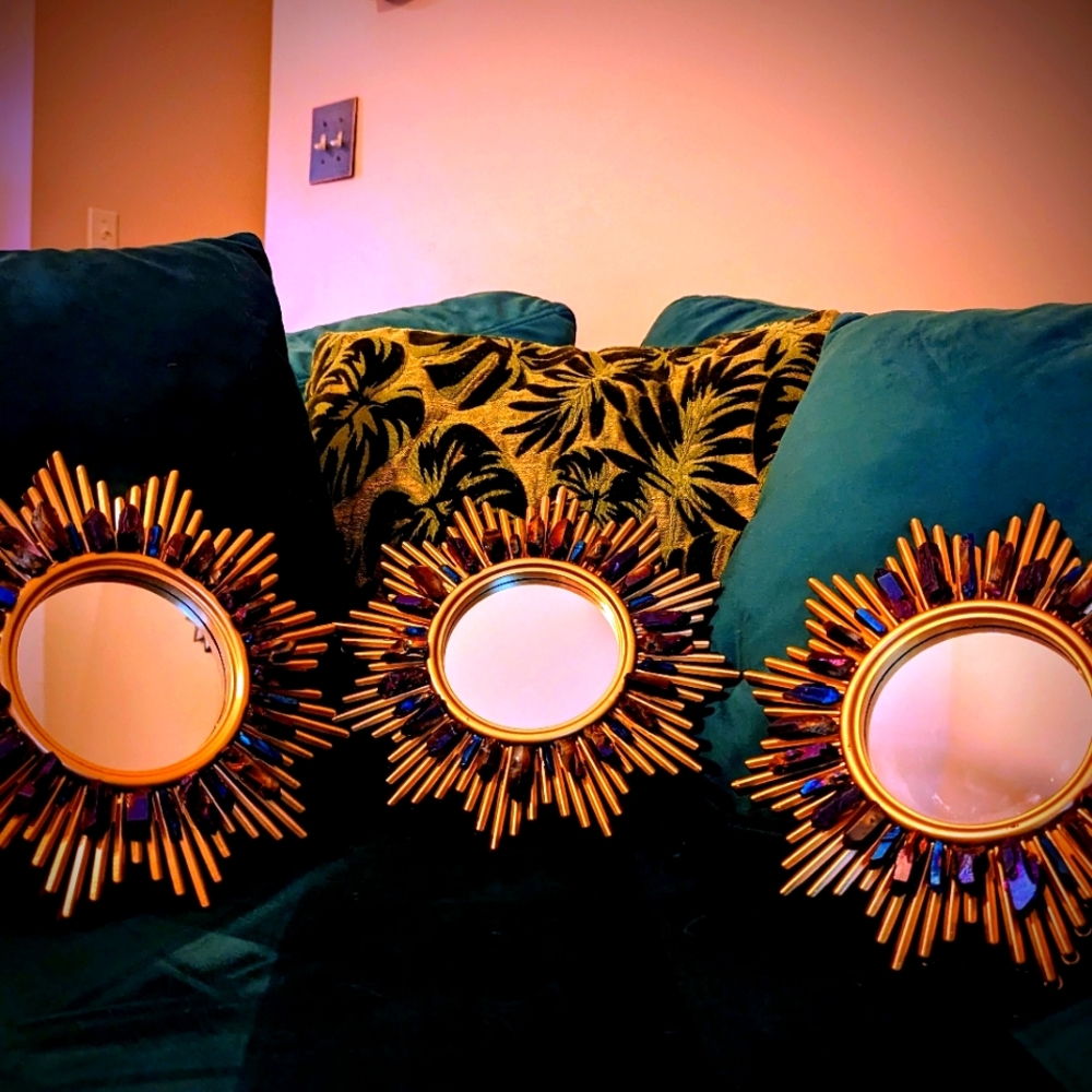 Set of three gold tone wall hanging accent mirrors with titanium coated quartz